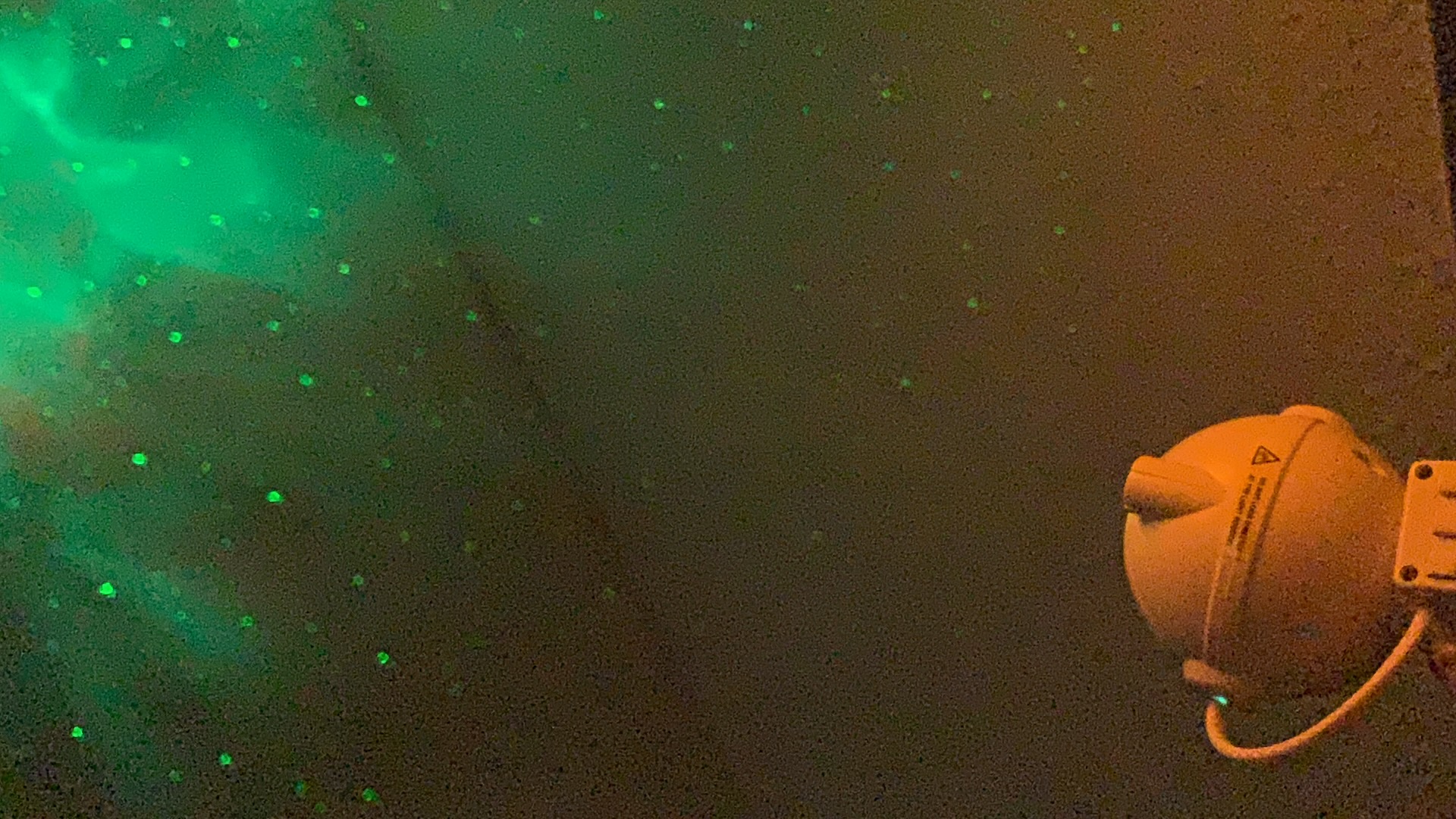 Green nebula light effect projected on a ceiling, real customer photo